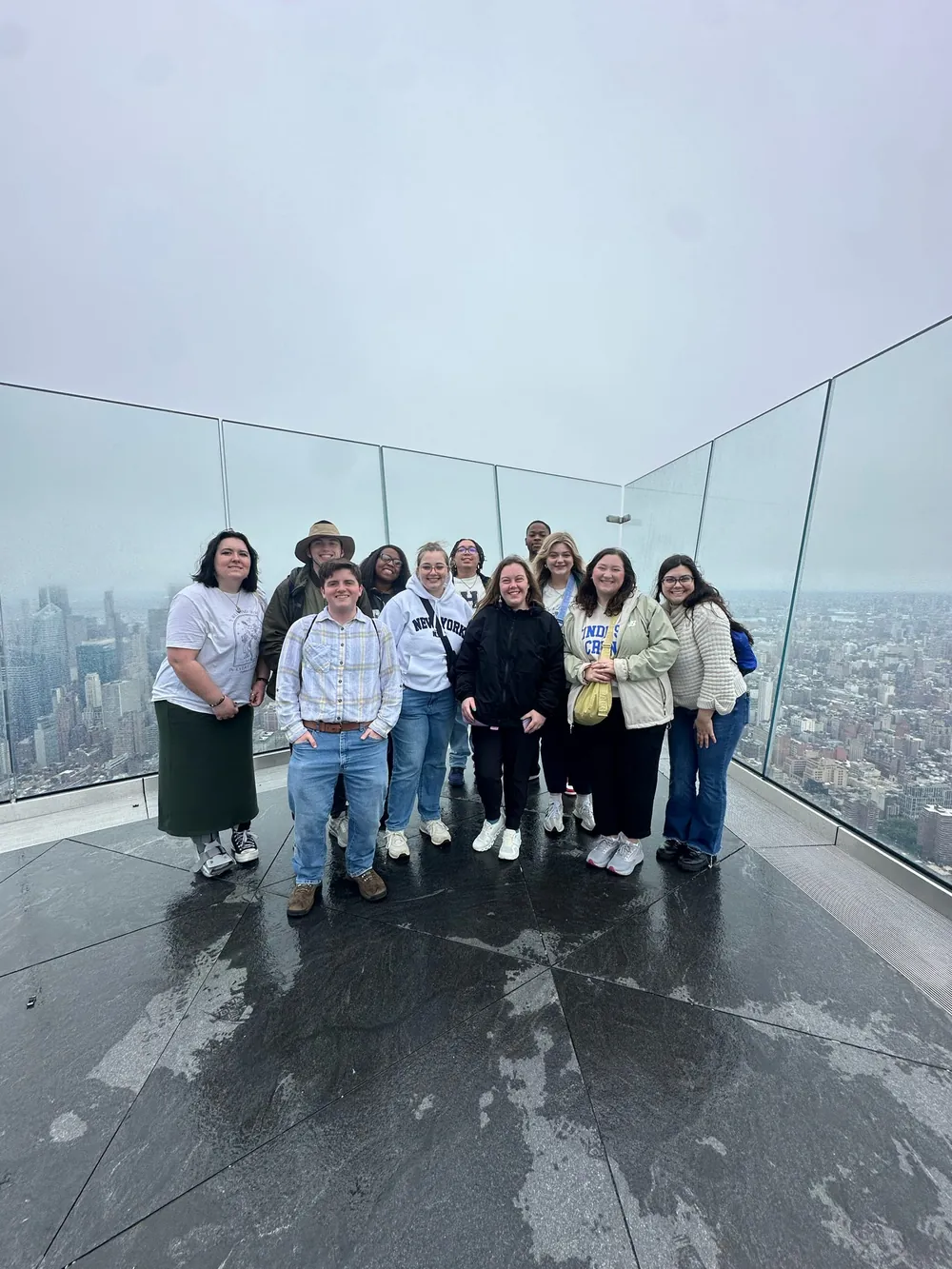 Group photo on a tall building overlooking a city skyline
