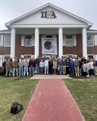 Fraternity members posed on a fire truck out front of the Pi Kappa Alpha house.