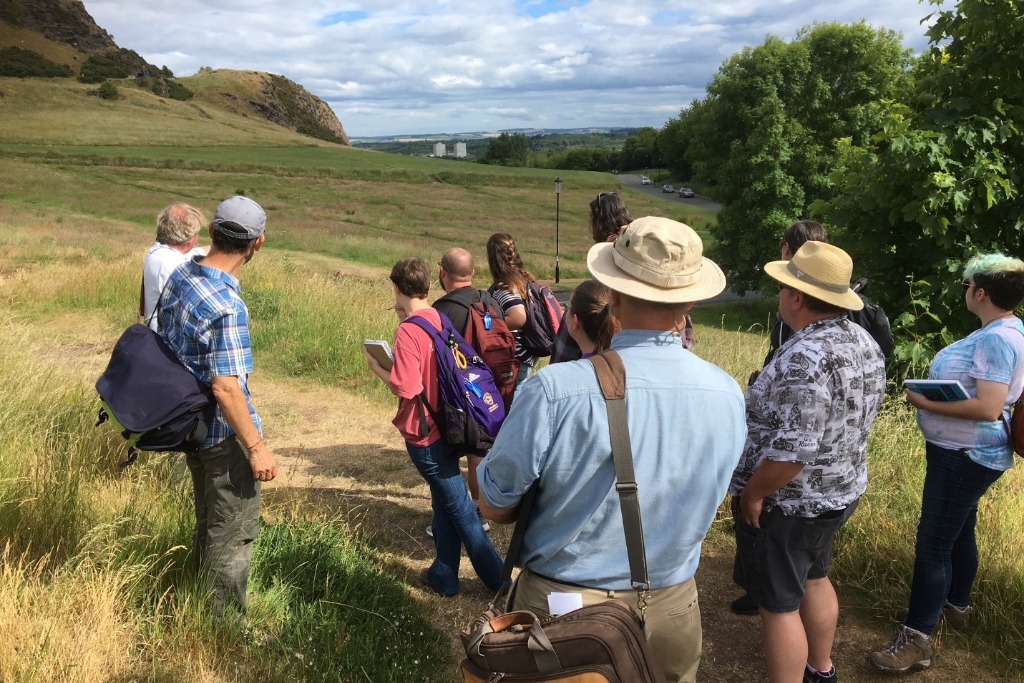 Students surveying a field with a guide in Scotland