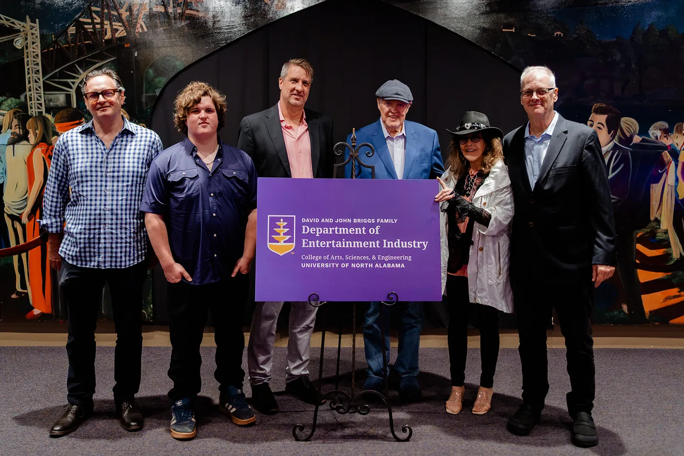 A group photo around a Departmennt of Entertainment Industry sign