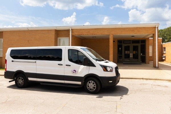 UNA shuttle van in front of doors at East Campus