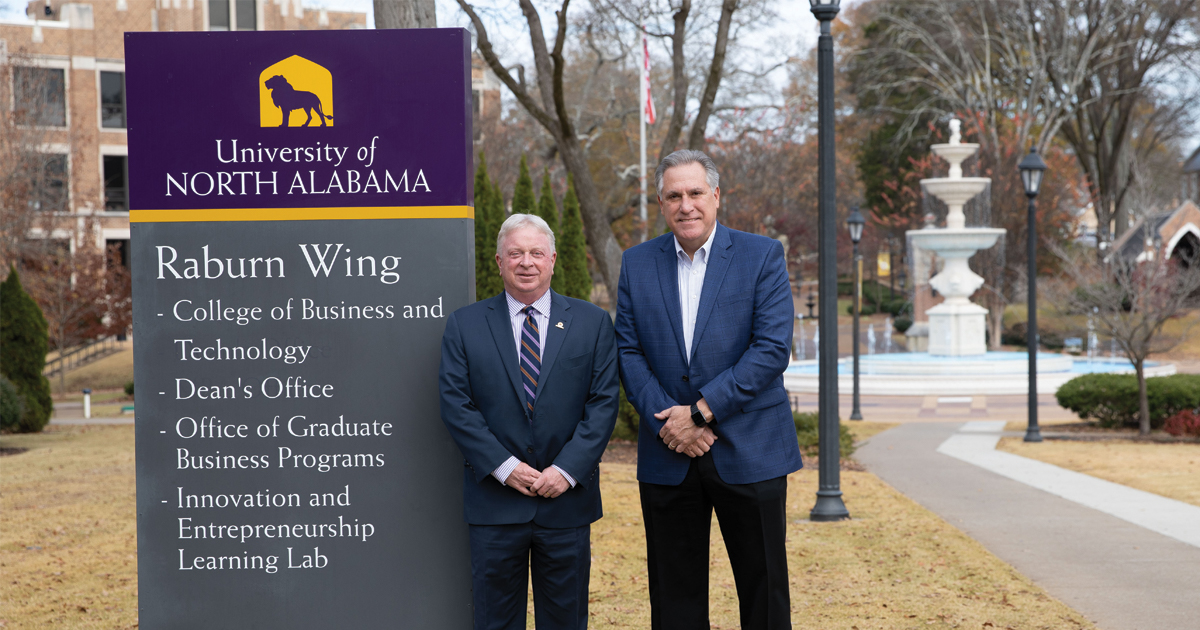 College of Business and Technology Dean Greg Carnes and Lyons HR, LLC Founder Bill Lyons stand in front of the Raburn Wing of Keller Hall on campus at the University of North Alabama.