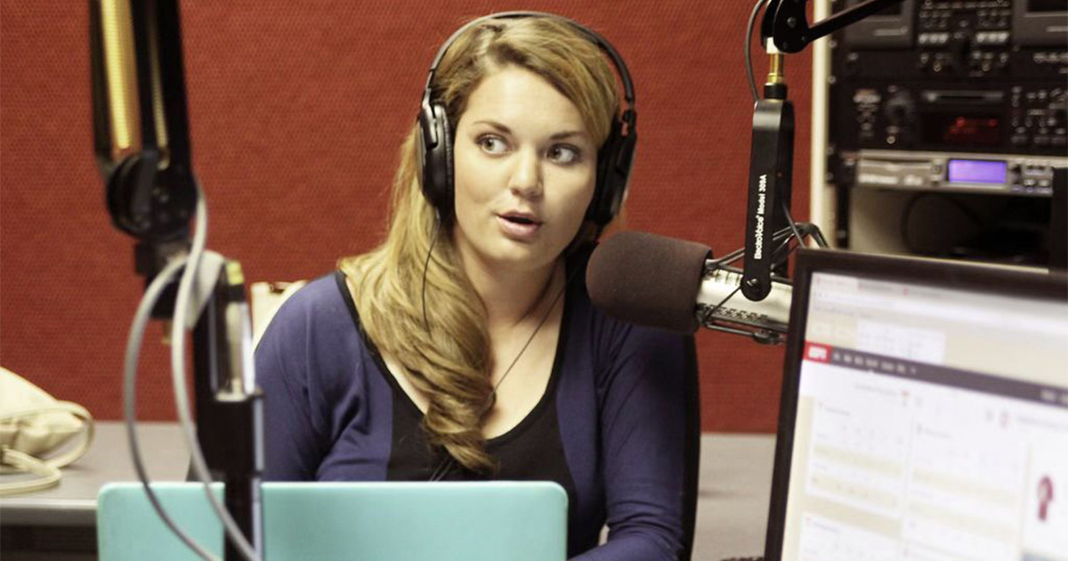 Avery King, a graduate of the Department of Communication speaks on the radio.