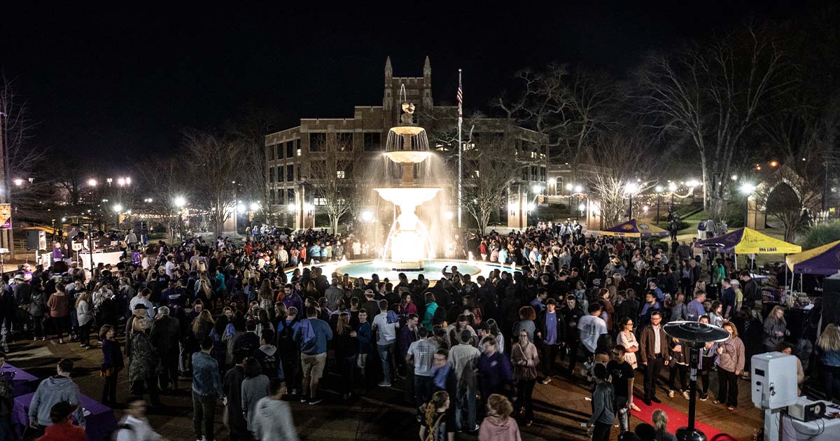 Members of the UNA community celebrate the lighting of Harrison Fountain.
