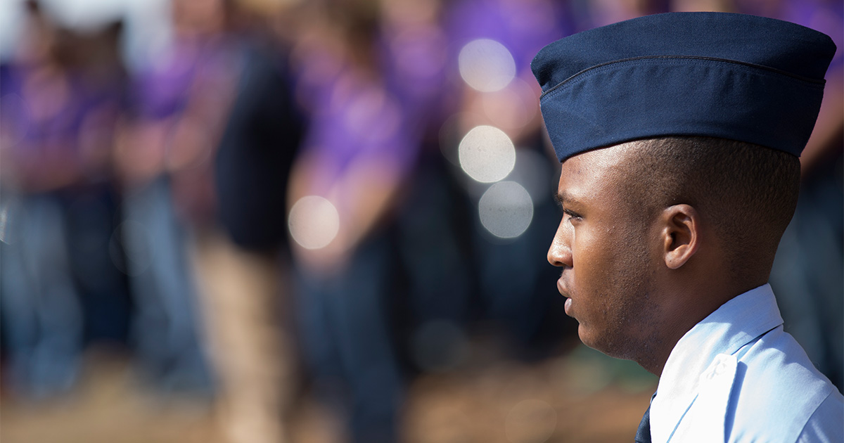 A member of the Air Force stands at attention for a campus even honoring veterans.