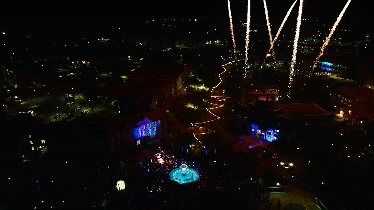 Drone overview of Light the Fountain event 2026, showcasing fireworks and a large crowd around the fountain