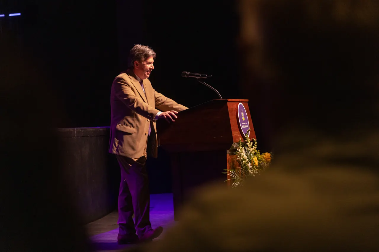 President Kitts speaking from a lectern on stage