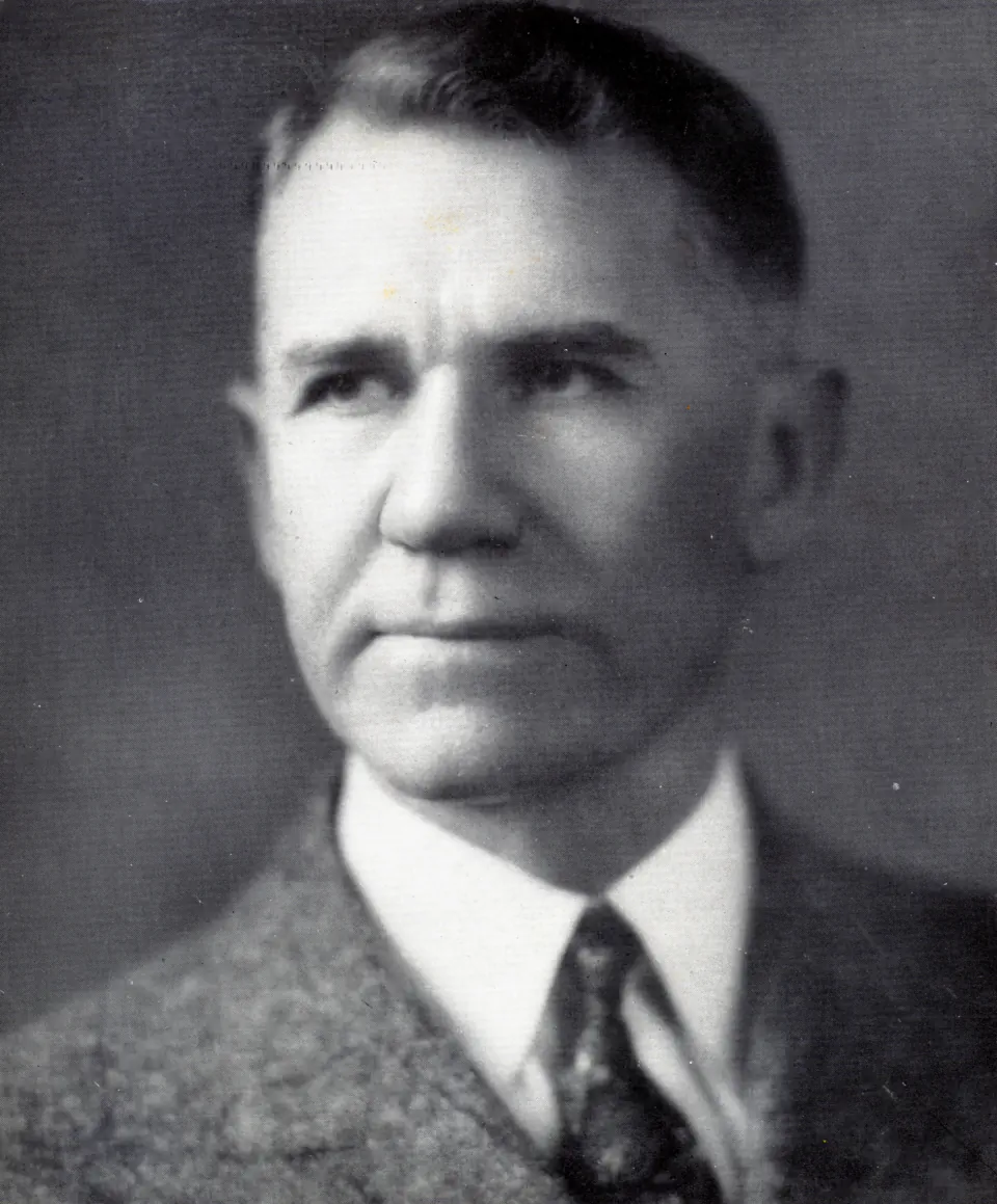 Studio portrait of Dr. Keller in a tweed jacket and patterned tie