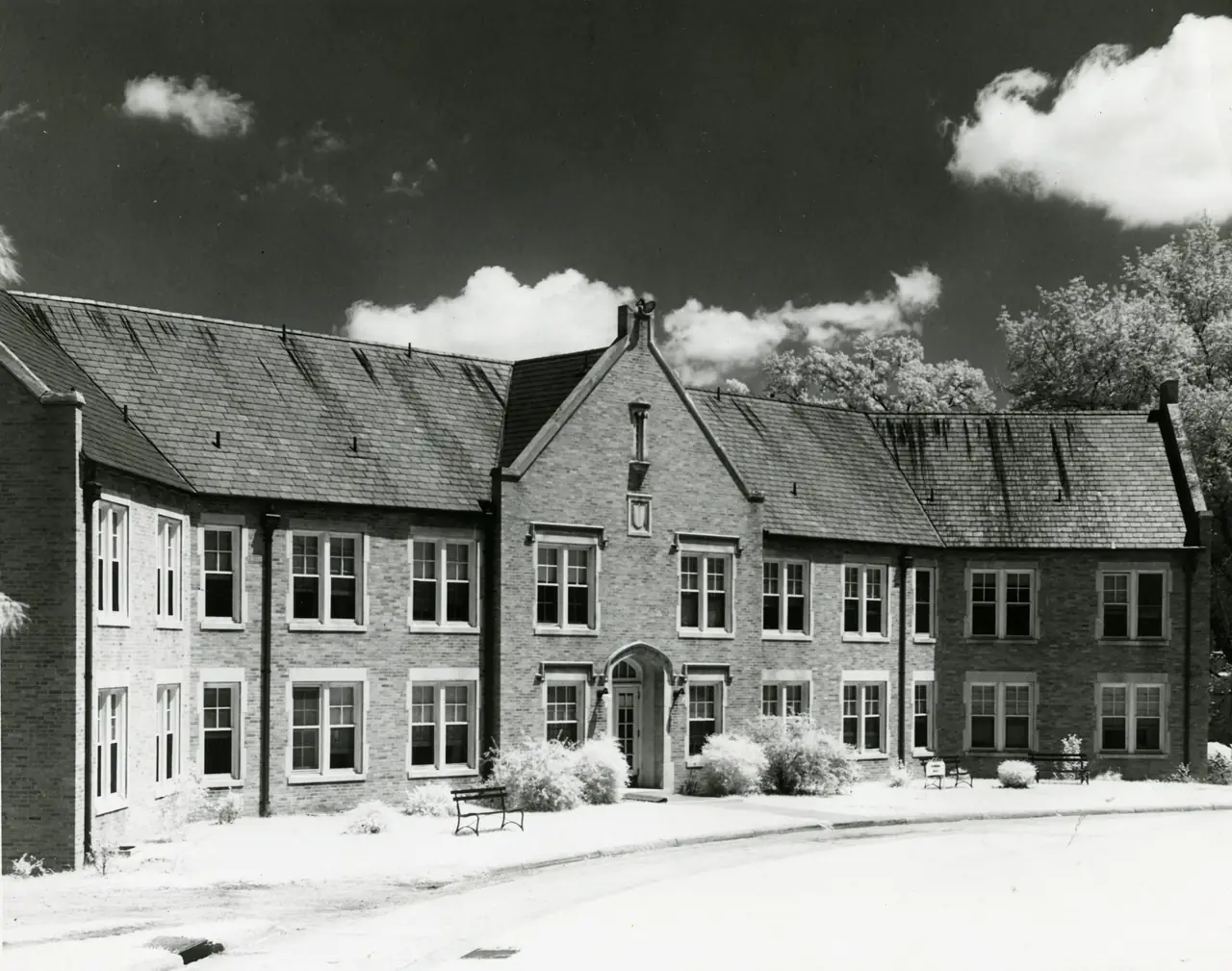 Powers Hall, a long two-story brick building under steep slate roofs