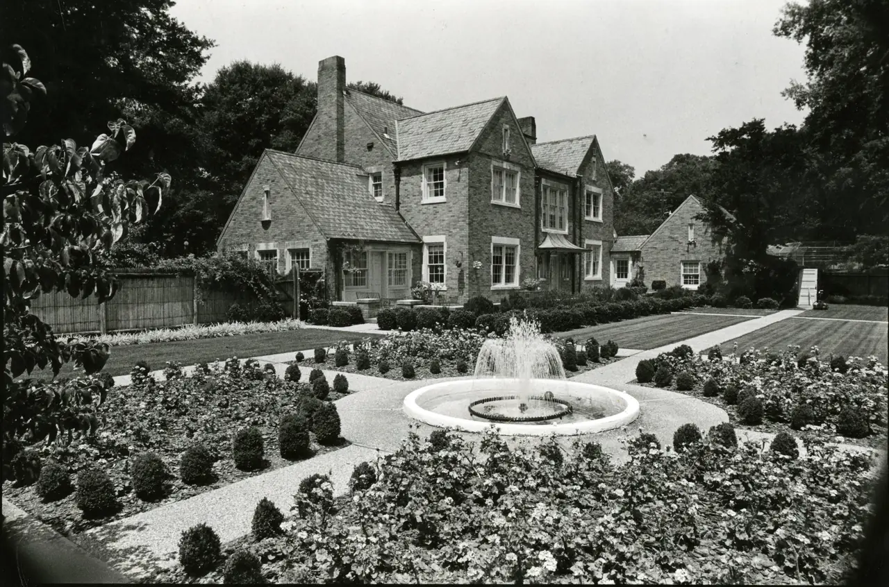The President&rsquo;s Home, a stone house with a formal garden and fountain in front