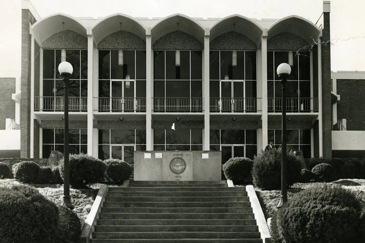 The Student Union Building, with a row of pointed arches along its roofline above a wide entrance stair