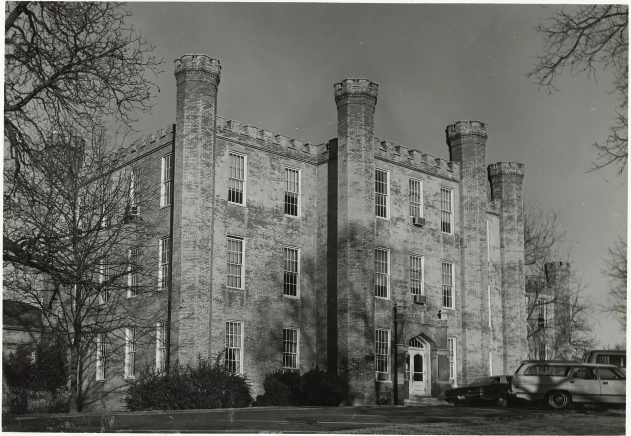 Wesleyan Hall, a three-story brick building with castellated towers at its corners