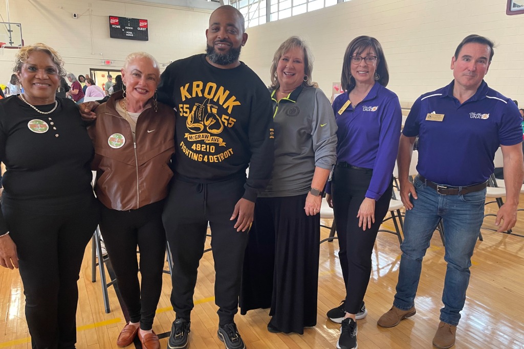 UNA Wellness employess with event attendees